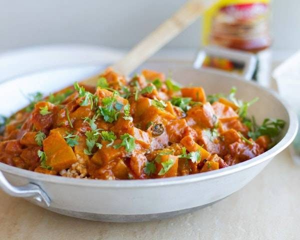 Squash coconut curry in a skillet.