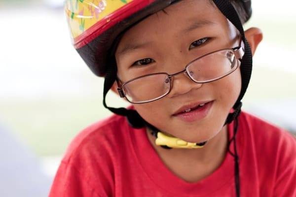 Young boy wearing a helmet.