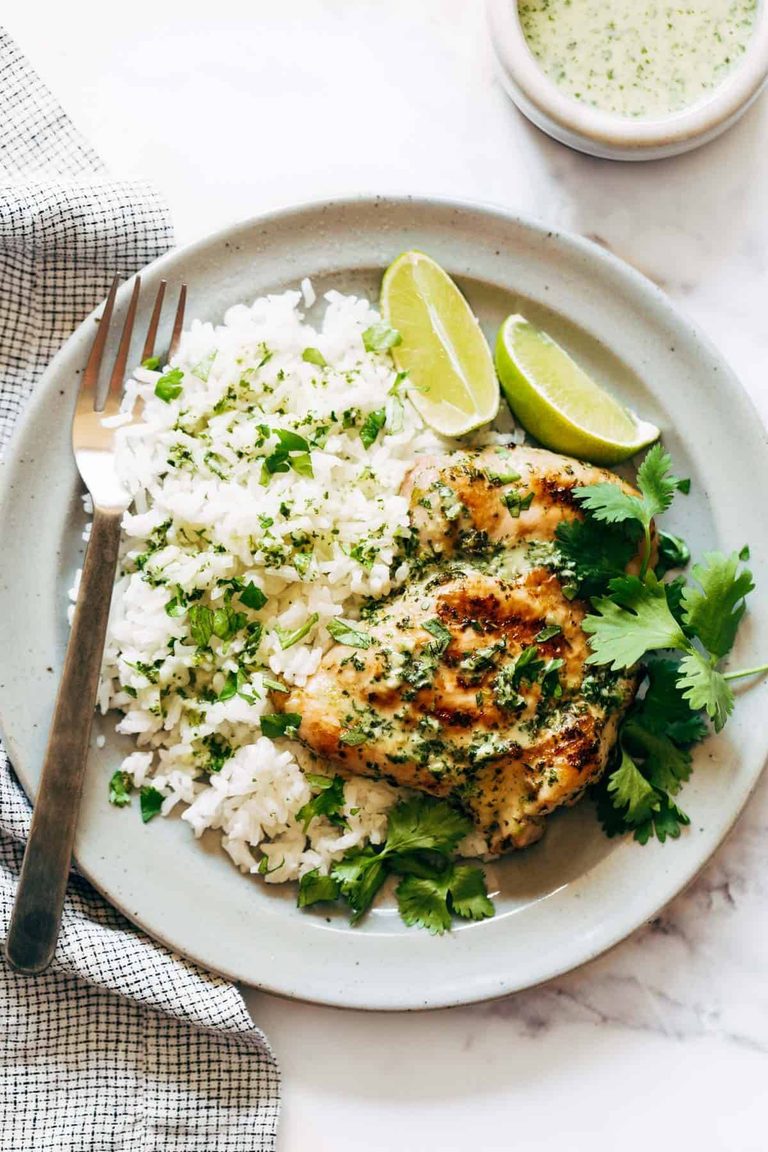 Coconut chicken on a plate with rice.