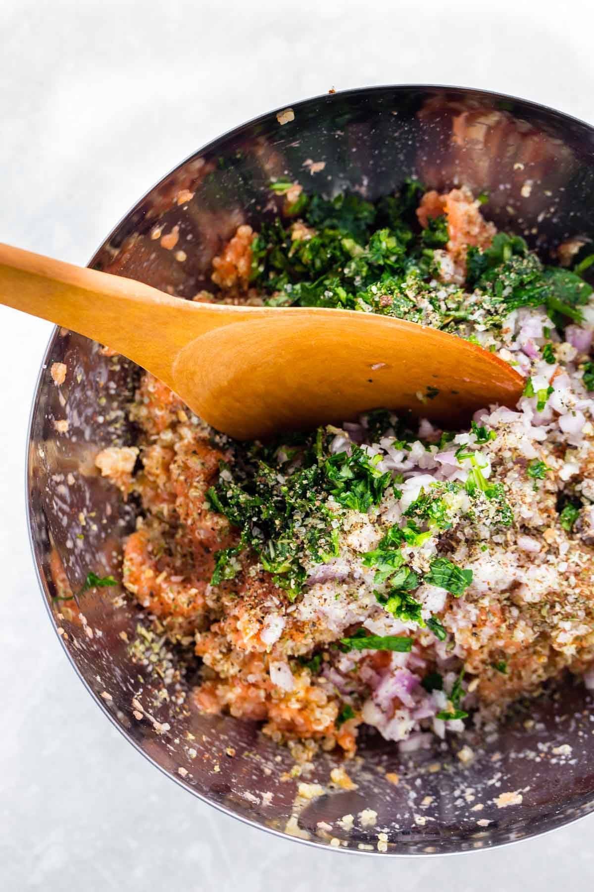 Salmon and herbs in a mixing bowl.