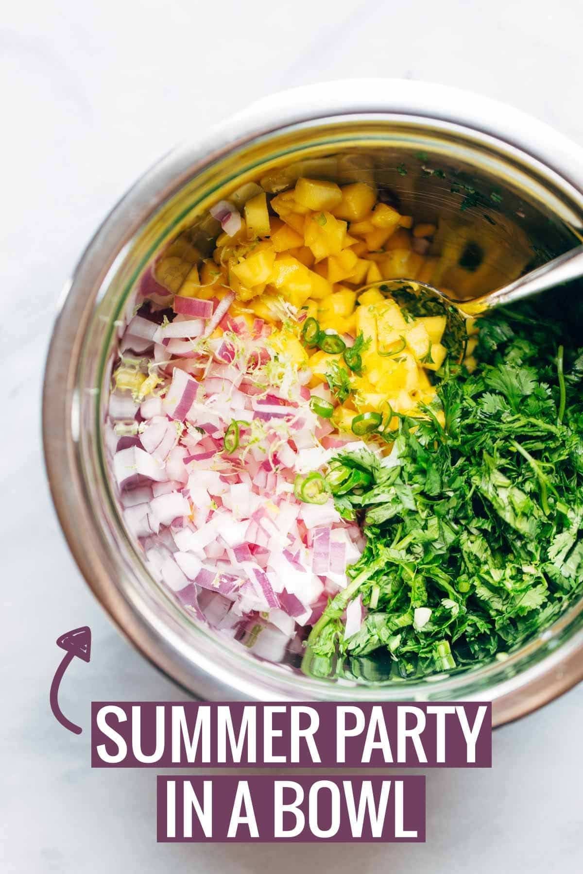 Green Curry Scallops with Mango Cilantro Salsa in a bowl with a spoon.